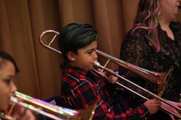 Young Boy With Green Hair Playing Trombone